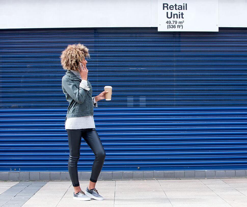 Image of young professional female outside of a retail unit.
