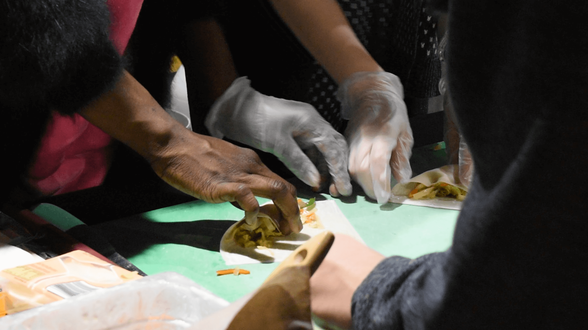 Image contains students preparing spring rolls
